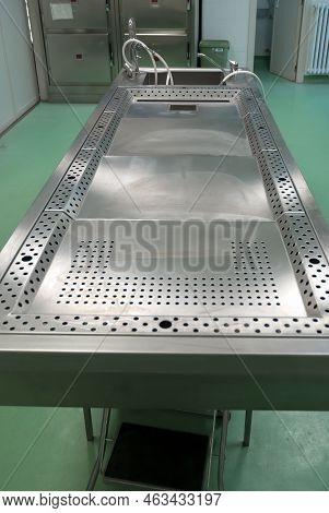 A Stainless Steel Work Table For Post-mortem Procedures And Dissections, Essential For The Medical E