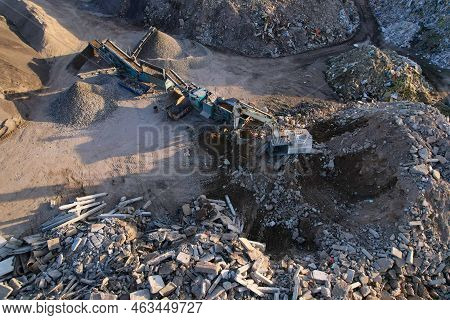 Excavator At Landfill The Load Concrete Waste In A Mobile Jaw Crusher Machine. Disposal Of Construct