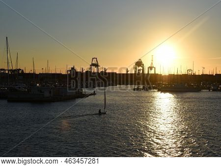 Sailboat On Sunset In Harbour. Sailing On Sea On Sailboat On The Waves. Yachtsman During Training On