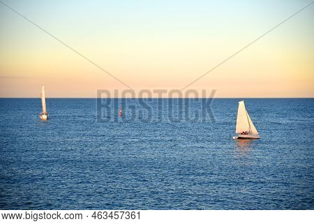 Sailboat At Sea On Sailing On The Waves. Yachtsman During Training On A Sailboat. Skiff And Sailboat