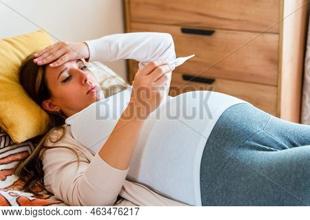 Pregnant Thermometer Temperature Check. Pregnancy Woman Holding Thermometer, Check Fever Flu Tempera