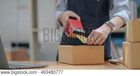 Close Up Online Business Owner Prepares Product For Delivery To The Customer. Online Entrepreneur Us