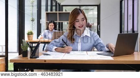Young Beautiful Woman Using Her Laptop While Sitting In A Chair At Her Working Place, Small Business