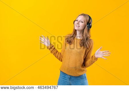 Woman Dancing To Music While Listening To Mp3 Player With Wired Headphones. Energy Move Of Caucasian