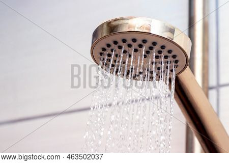 The Flow Of Water From The Watering Can In The Shower, Close-up. Taking A Shower
