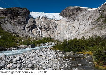 View On The Impressive Bergsetbreen Glacier With Snowcapped Mountains, Glacier Ice, Steep Rock Walls