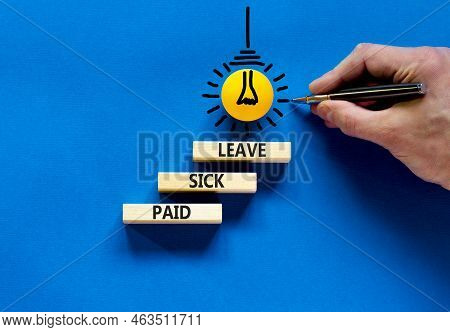 Paid Sick Leave Symbol. Concept Words Paid Sick Leave On Wooden Blocks. Doctor Hand. Beautiful Blue 