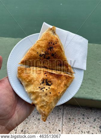 Turkish Pastry Borek With Minced Meat Served With Hand. Borek. Ready To Eat.