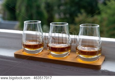 Flight Of Single Malt Scotch Whisky Served On Old Window Sill In Scottisch House With View On Old Pa