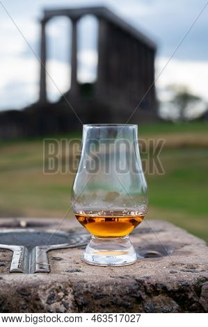 Glass Of Single Malt Scotch Whisky And View From Calton Hill To Park And Old Parts Of Edinburgh City