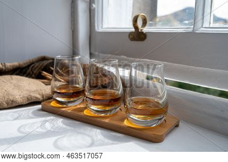 Flight Of Single Malt Scotch Whisky Served On Old Wooden Window Sill In Scottisch House In Edinburgh