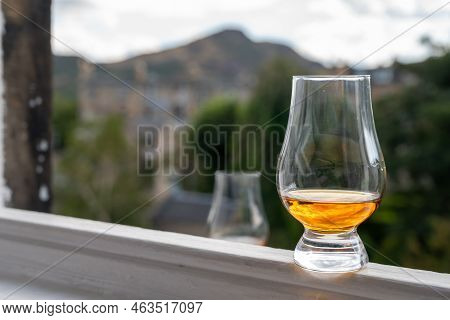 Glass Of Single Malt Scotch Whisky Served On Old Window Sill In Scottisch House With View On Old Par