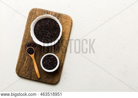 Quinoa Seeds In Bowl And Spoon On Colored Background. Healthy Kinwa In Small Bowl. Healthy Superfood