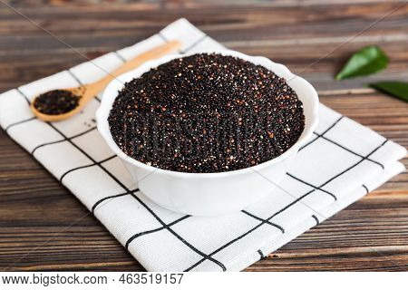 Quinoa Seeds In Bowl And Spoon On Colored Background. Healthy Kinwa In Small Bowl. Healthy Superfood