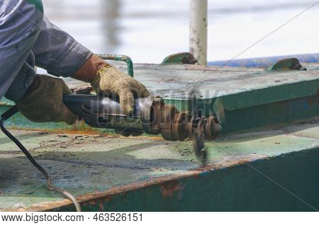 Close Up Of Worker Hand Using Electric Steel Cracker To Cracking Rusty Stern Floor Of Oil Tanker