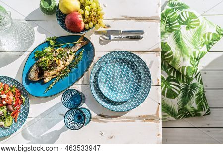 Gilt-head Bream Also Known As Orata Baked In The Oven And Served On A White Wooden Table With Vegeta