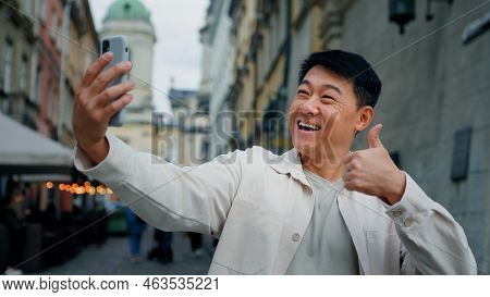 Joyful Adult Male Tourist Holding Smartphone Looking At Screen Taking Pictures On Webcam Happy Man B