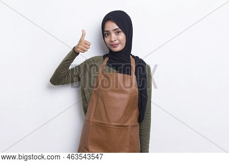 Asian Muslim Woman Barista Waitress Wearing Apron With Ok Sign Gesture Tumb Up Isolated On White Bac