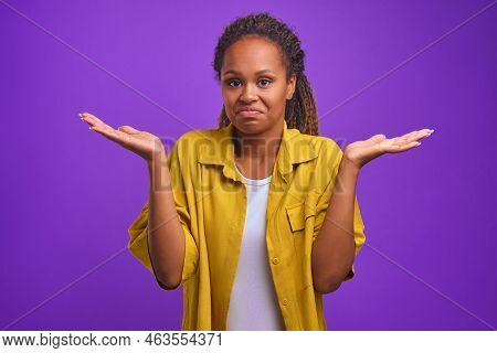 Young Attractive African American Woman Throws Up Hands As Sign Uncomprehending