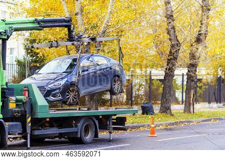 Tow Truck With The Help Of A Crane Loads The Car