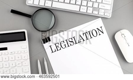 Legislation Written On Paper With Office Tools And Keyboard On Grey Background