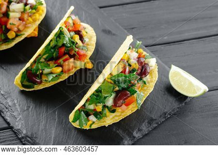 Tacos With Salsa. Mexican Tacos With Vegetarian Filling On A Dark Background. Trend 2022 Reducetaria