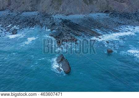 Aerial Drone Landscape Bird's Eye View Of Sunset Over Welcombe Mouth Beach In Devon England