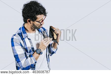 Man With Financial Problems Showing Empty Wallet. Moneyless Frustrated Person Concept. Sad Man Shaki