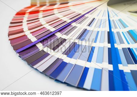 Color Guide Close Up. Assortment Of Colors For Design. Colors Palette Fan On White Concrete Wall Bac