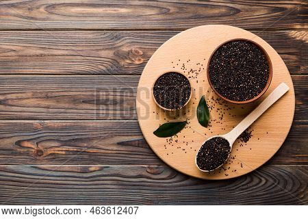 Quinoa Seeds In Bowl And Spoon On Colored Background. Healthy Kinwa In Small Bowl. Healthy Superfood