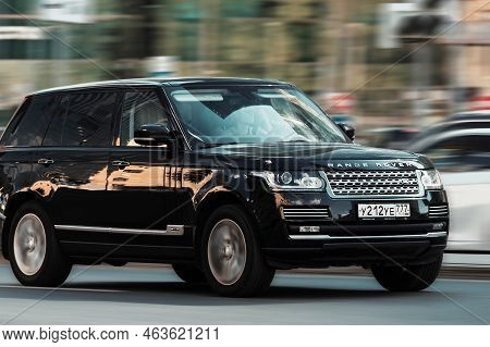 Car Range Rover L405 Side View. Sport Suv Black Color Driving Against Blurred City Background. Full 
