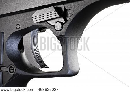 Large Semi-automatic Handgun Trigger Closeup Isolated On A White Background.