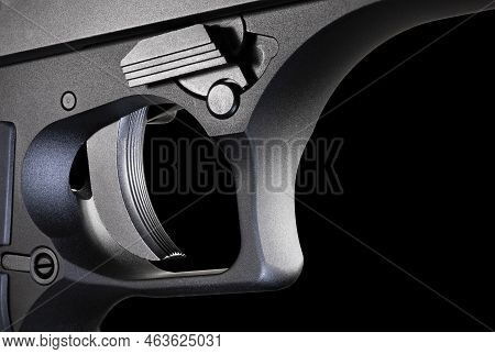 Trigger For A Large And Metal Framed Semi Automatic Handgun That Is On A Black Background.