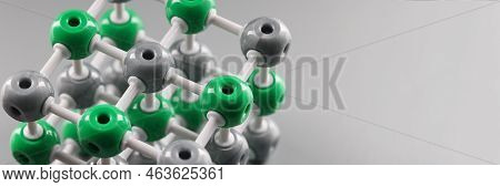 Plastic Model Of A Molecule, Crystal Lattice Of An Atom On A Gray Background, Close-up. Organic Chem