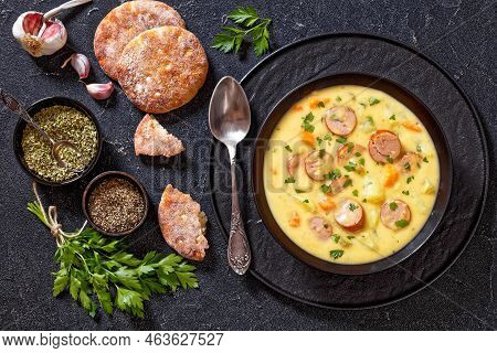 Kartoffelsuppe, German Potato Soup With Sausages In Black Bowl On Dark  Concrete Table, Horizontal V