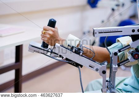 Woman Wear Machine Arm For Physical Therapy. By Defining How A Robot Driven Moving Technique Can Be
