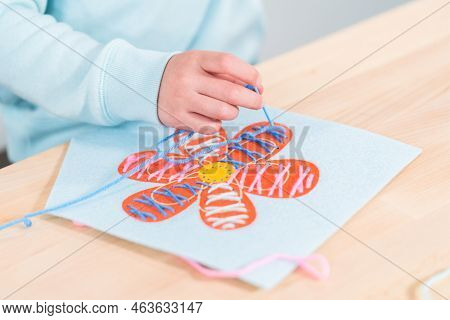 Little Girl Learning How To Sew With Sewing Craft Kit For Kids.