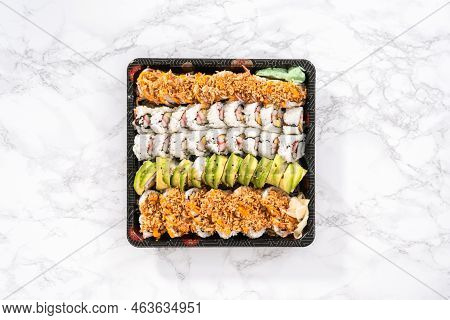 Flat Lay. Pre-packaged Variety Of Sushi And Sushi Rolls In A Plastic Tray.