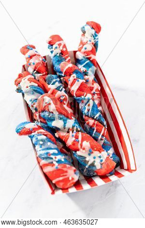 Patriotic Cinnamon Twists Drizzled With A White Glaze And Decorated With Star Sprinkles.