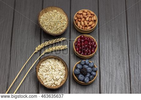 Ingredients For Balanced Breakfast. Oatmeal, Cranberries And Blueberries In Wooden Bowls. Sprigs Of 