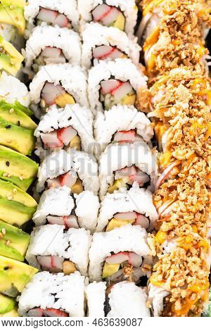 Pre-packaged Variety Of Sushi And Sushi Rolls In A Plastic Tray.