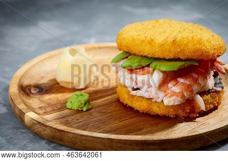 Pan-asian Cuisine Concept. Japanese Sushi Burger Made From Rice Bread, Crab Meat, Avokado And Wasabi