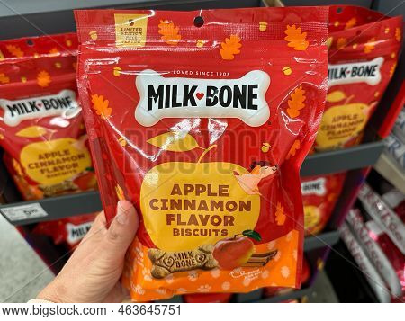 Plymouth, Minnesota - October 14, 2022: Hand Holds Up Milk Bone Apple Cinnamon Flavor Dog Biscuits T