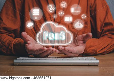 Paas - Platform As A Service, Man Hand Holding Paas Icon On Vr Screen On Desk Background, Internet T