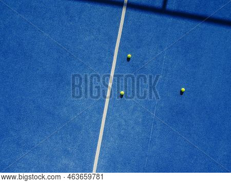 Three Balls On A Blue Paddle Tennis Court, Drone Aerial View