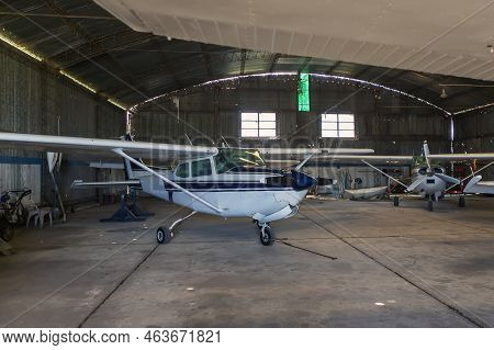 Old Angar With Several Airplanes Ready For Flight.