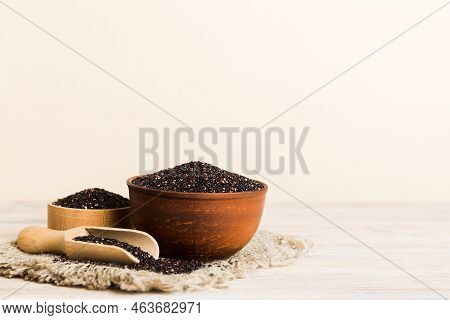 Quinoa Seeds In Bowl And Spoon On Colored Background. Healthy Kinwa In Small Bowl. Healthy Superfood