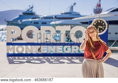 Porto Montenegro Translates As Port Of Montenegro. Woman Tourist On Background Of Yacht Marina, Beau