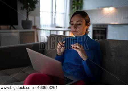 Tired Businesswoman In Blue Sweater Works On Business Project From Home. Overworked Female Entrepren