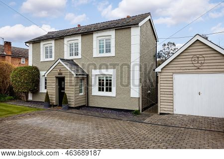 Stradishall, England - March 21 2016: Detached Traditional Cottage With Paved Driveway And Garage